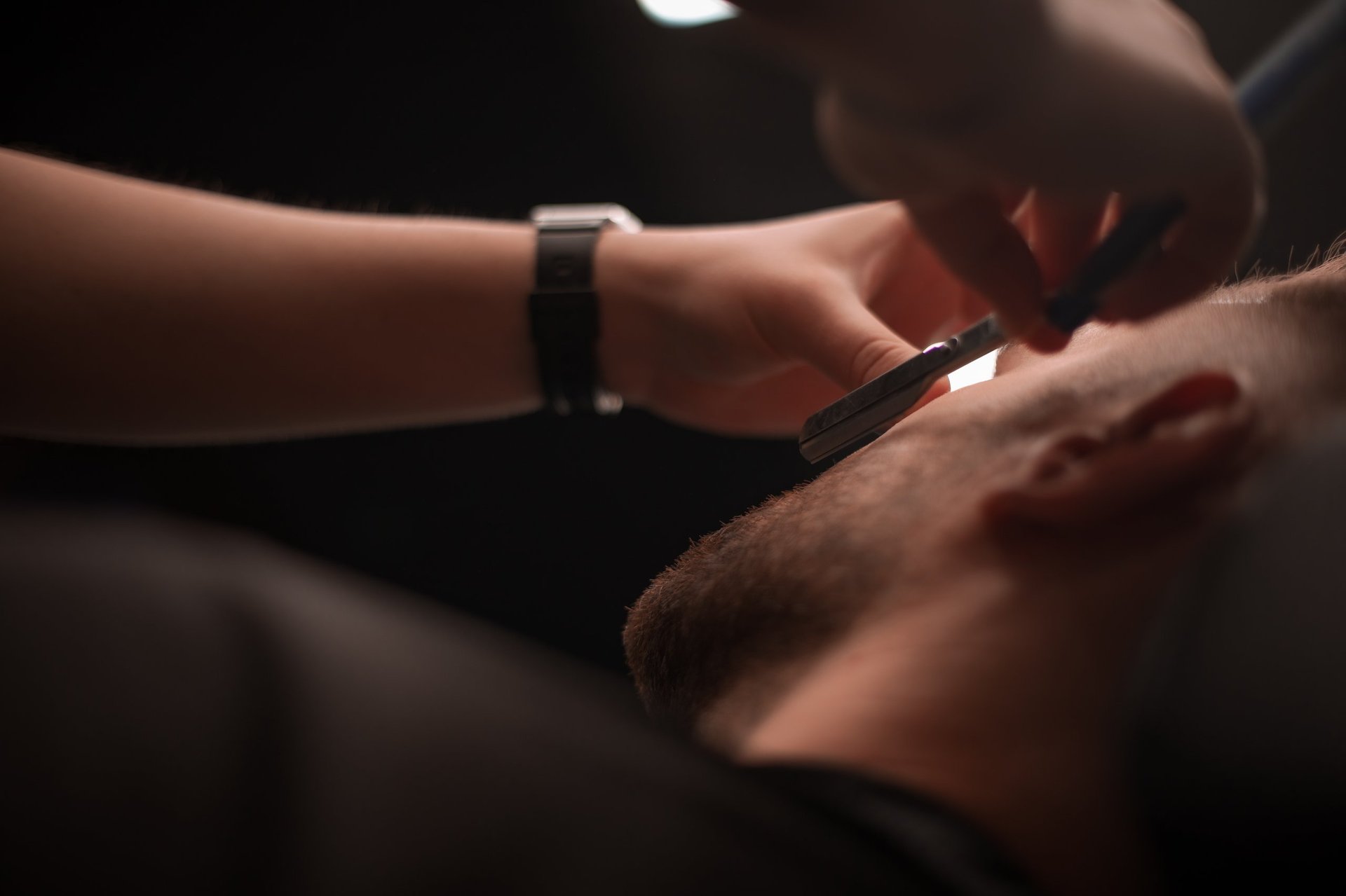 Barber performing a precision straight razor shave